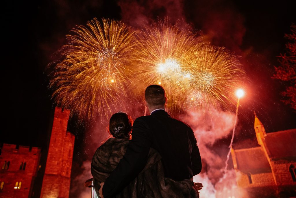 Bride and Groom watching there firework display at Peckforton Castle Fireworks By Myweddingfireworks.com